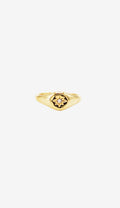 Gold ring with a central gemstone on a white background